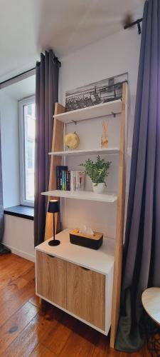 une étagère dans une chambre avec fenêtre dans l'établissement Le Cocon de Soubise - Centre-ville et calme, à Dunkerque