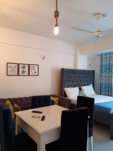 una sala de estar con un sofá y una cama en 5 Minutes to the Beach - Studio, en Mombasa
