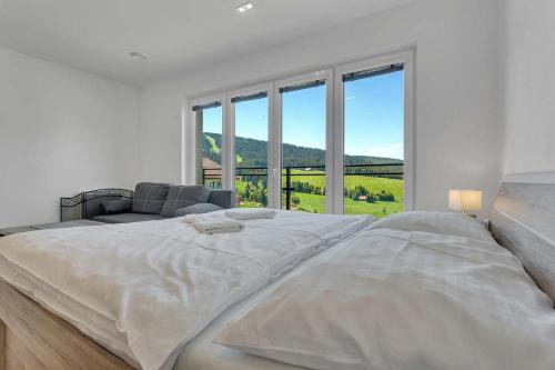 Postel nebo postele na pokoji v ubytování Family Apartments Klínovec