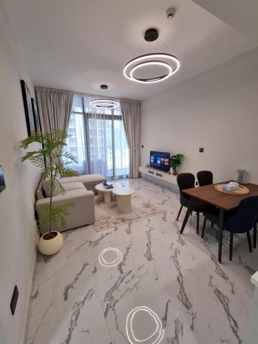a living room with a table and a couch at Maryah Vista in Abu Dhabi