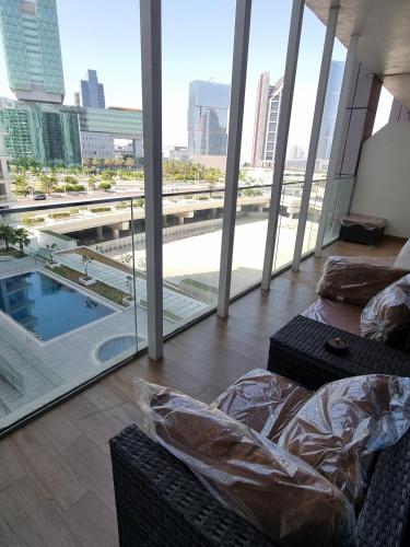 a living room with a view of a city from a building at Maryah Vista in Abu Dhabi