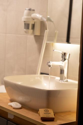 a white sink sitting on top of a wooden counter at Kadim Hotel in Mardin