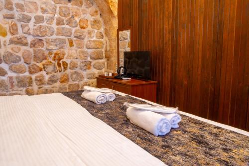 a bedroom with a bed with towels on it at Kadim Hotel in Mardin