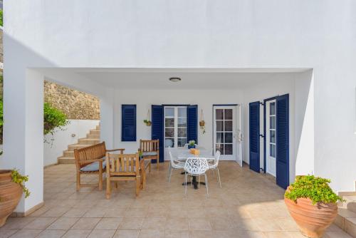 a dining room with a table and chairs on a patio at Thanos Luxurious Apt in Spetses Center, 2BR, 2BA in Spetses