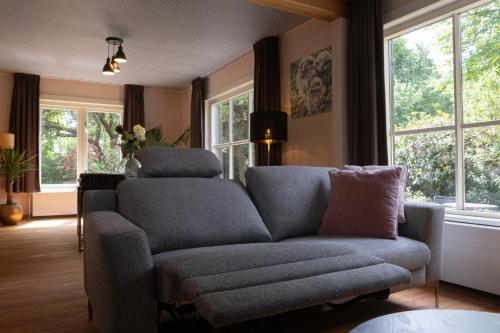 a living room with a couch and a chair at Boerenvakantie in Hilversum