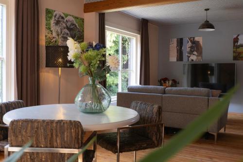 a living room with a vase of flowers on a table at Boerenvakantie in Hilversum