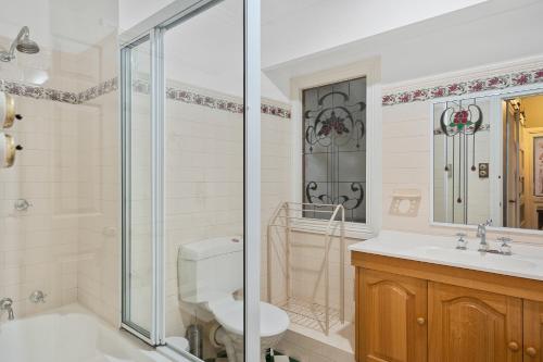 a bathroom with a shower and a toilet and a sink at Rose Room, Franklin Lodge, Huon Valley in Franklin