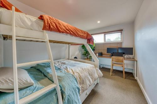 a bedroom with two bunk beds and a desk at Acacia Rise - The Ultimate Peninsula Getaway in Cape Schanck