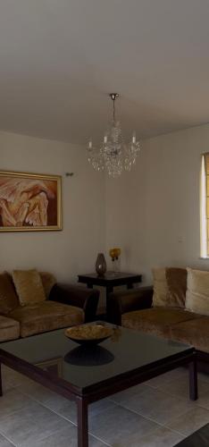 a living room with a couch and a table at Maison Andre in Pano Lefkara