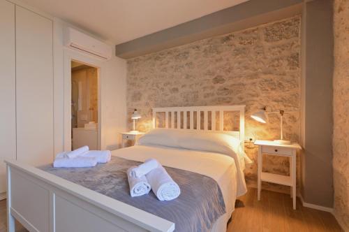 a bedroom with a bed with towels on it at Villa Ante in Zaostrog