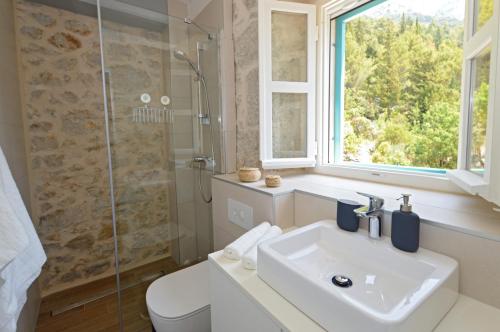 a bathroom with a sink and a shower at Villa Ante in Zaostrog