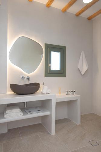 a bathroom with a sink and a mirror at À La Plage Residences 02 in Platis Gialos