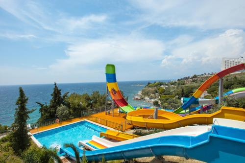 a water park with a pool and a roller coaster at Sealight Resort Hotel in Kusadası