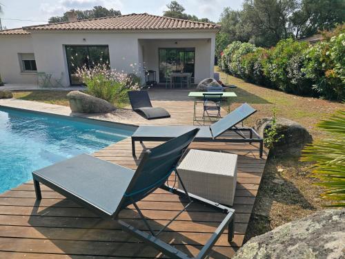 a patio with chairs and tables next to a pool at Maison climatisée de 3 chambres avec piscine privée in Sotta