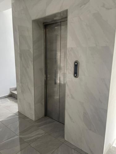 a elevator in a building with a cell phone on the wall at Chic City Oasis at Gazebo in Addis Ababa