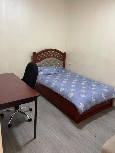 a bedroom with a bed and a desk and a chair at Chic City Oasis at Gazebo in Addis Ababa