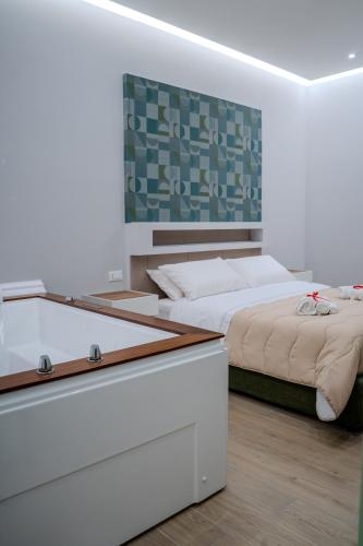 a bedroom with two beds and a mirror at Luxury Acclavio Apartments in Taranto