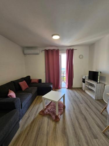 a living room with a couch and a table at Open Sky Montenegro in Utjeha