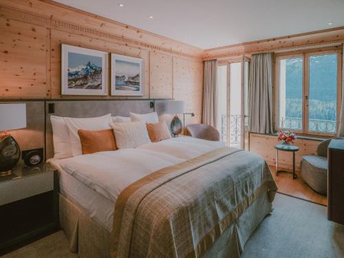 a bedroom with a large bed in a room at Kulm Hotel St. Moritz in St. Moritz