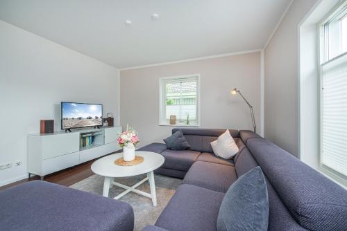 a living room with a couch and a table at Ferienhaus Witt in Neue Tiefe Fehmarn