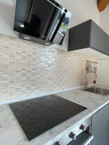 a kitchen with a sink and a counter top at Apartment Murnera in Mozzate