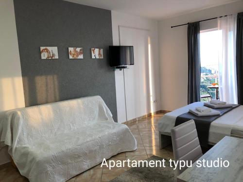 a bedroom with a bed and a table and a chair at Open Sky Montenegro in Utjeha