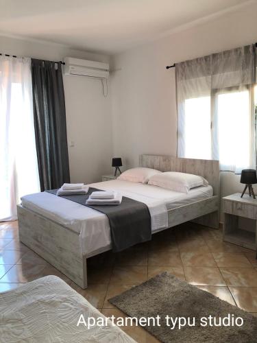 a bedroom with a large bed in a room at Open Sky Montenegro in Utjeha