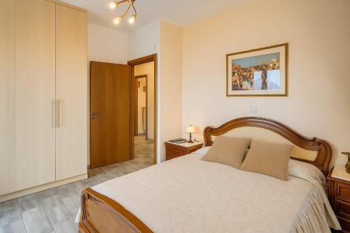 a bedroom with a large bed and a door at Filistron Seaview Bliss - Coastal Secluded Gem in Taktikoúpolis