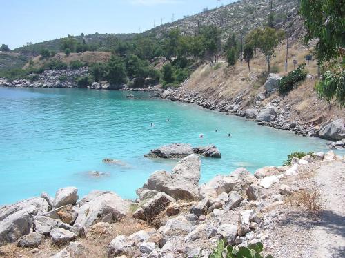 a group of people swimming in a body of water at Filistron Seaview Bliss - Coastal Secluded Gem in Taktikoúpolis