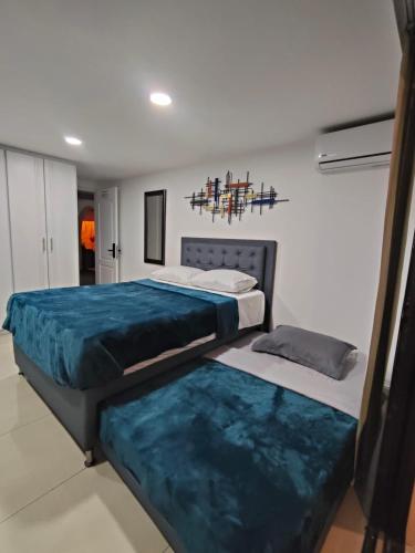 two beds sitting in a room with at Glam House Hotel in Medellín