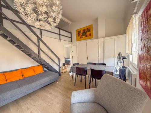 un salon avec un canapé, une table et des chaises dans l'établissement Appartement pour 6 personnes , plage de Saint Clair, au Lavandou