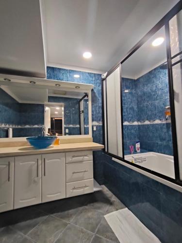 a bathroom with a sink and a mirror and a tub at Glam House Hotel in Medellín