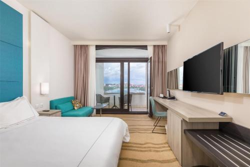 a hotel room with a bed and a flat screen tv at Park Plaza Histria Pula in Pula