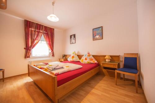 1 dormitorio con 1 cama, 1 silla y 1 ventana en Hotel Burghof en Stolberg