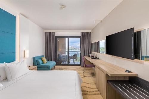 a hotel room with a bed and a flat screen tv at Park Plaza Histria Pula in Pula