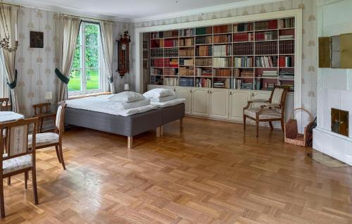 a bedroom with a bed and bookshelves at 2 Bedroom Cozy Apartment In Mullsjö in Mullsjö