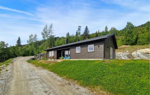 a house on a dirt road next to a dirt road at Nice Home In Hafslo With Wifi in Hafslo