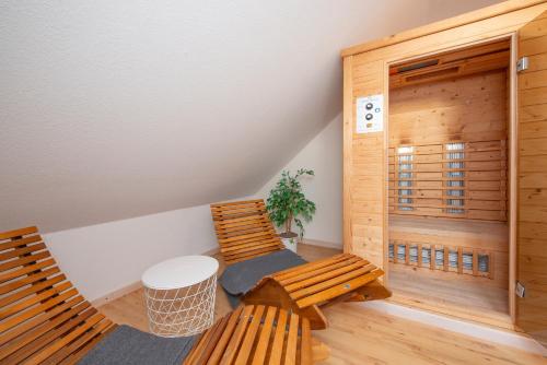 two wooden benches in a room with a sauna at Wenkendorf 52 MeErholung in Wenkendorf auf Fehmarn