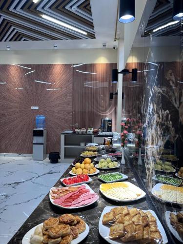 a buffet line with many different types of food at North Star Hotel in Yakkasaray