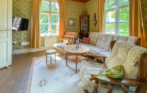 a living room with a couch and a table at 3 Bedroom Pet Friendly Home In Grimsås in Grimsås