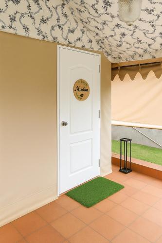 a room with a white door with a sign on it at Vanaswara in Kolād