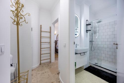 a white bathroom with a sink and a mirror at DeCaNa Prestige Apartment - Gated Community Algarve in Porches