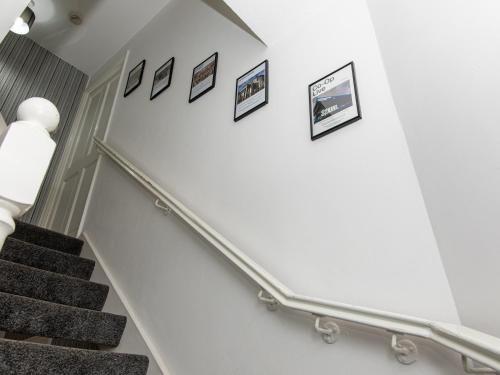 a stairway with pictures on the wall at Manchester 2Bedroom Near Etihad Stadium & Coop Live Arena in Manchester