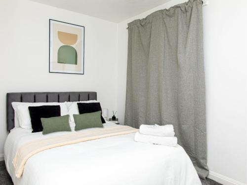 a bedroom with a large white bed and a window at Manchester 2Bedroom Near Etihad Stadium & Coop Live Arena in Manchester