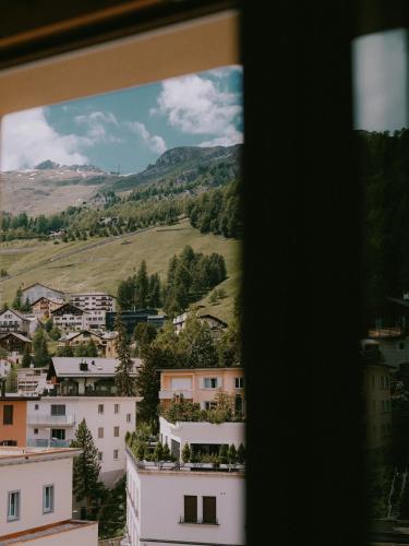 a view of a city from a window at Kulm Hotel St. Moritz in St. Moritz