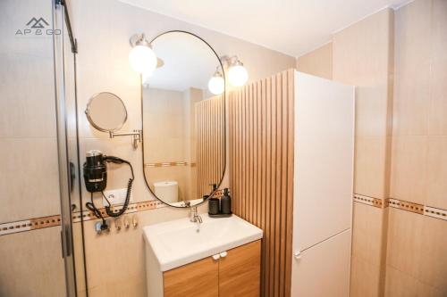 a bathroom with a sink and a mirror at Fuerte Luxury Penthouse & Jacuzzi in La Herradura