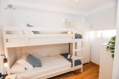 a white bunk bed in a room at Fuerte Luxury Penthouse & Jacuzzi in La Herradura