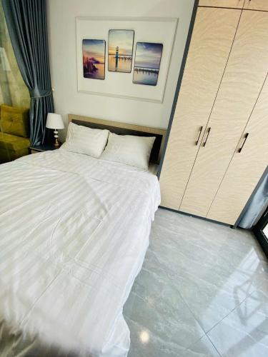 a bedroom with a large white bed and cabinets at Lilo's Homestay West Lake Thuy Khue in Hanoi