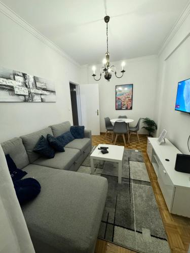 a living room with a couch and a table at Modern 2BR Apartment with City Views I Near Lisbon by LivinInLisboa in Queluz