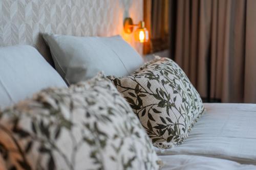 a bed with two pillows on top of it at Two Brothers Noordwijk Beach in Noordwijk aan Zee